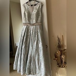 Silver lace formal gown with a V back . Attached crystal belt.